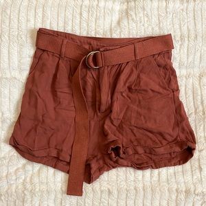 Burnt orange colored shorts with clothe belt.